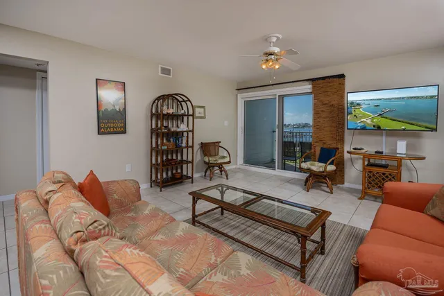 a living room with furniture a rug and a chandelier