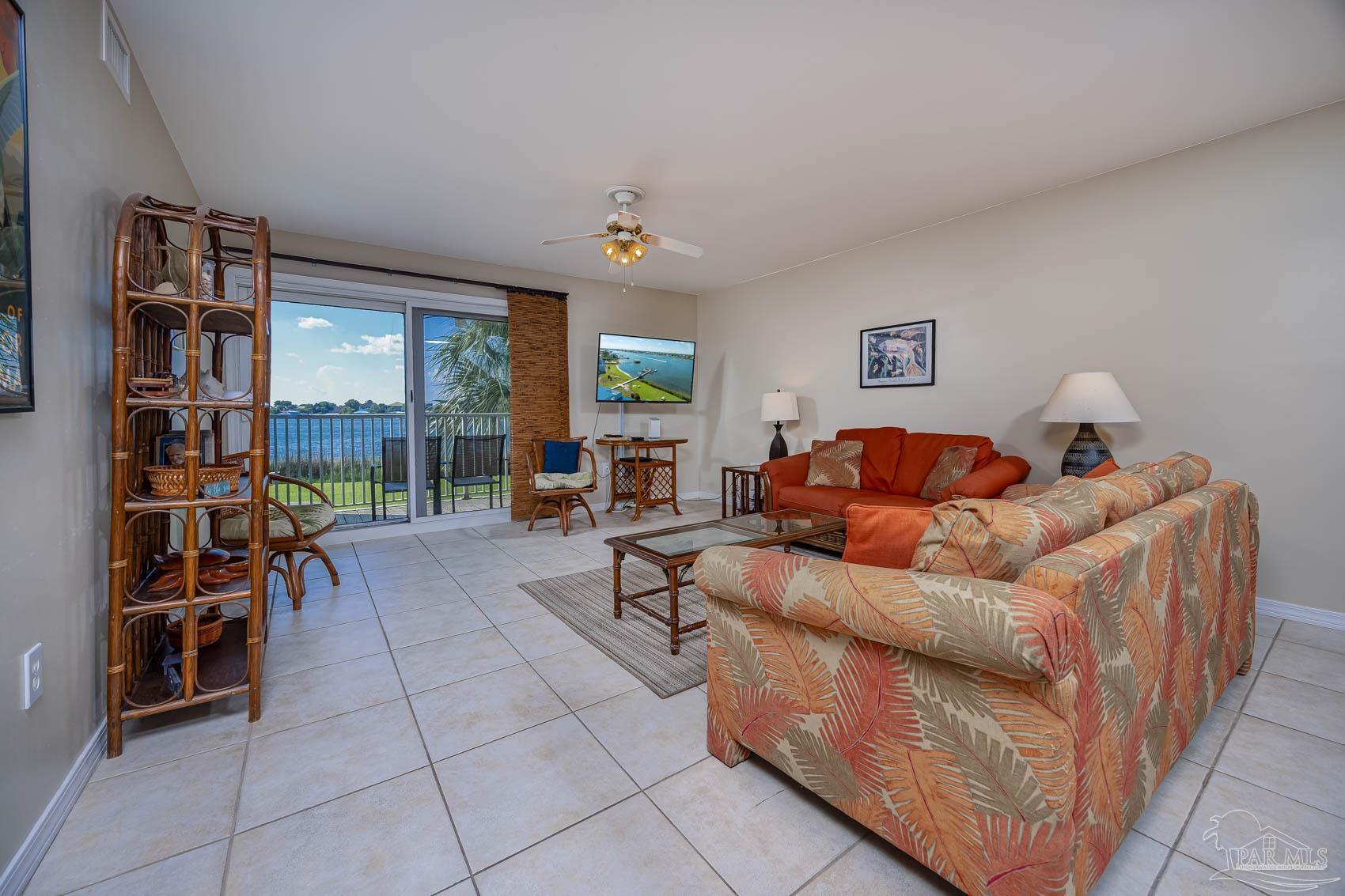 16470 Perdido Key Drive, Unit B13 Perdido Key, FL 32507 - Photo 16 of 30 a living room with furniture a bookshelf and a window