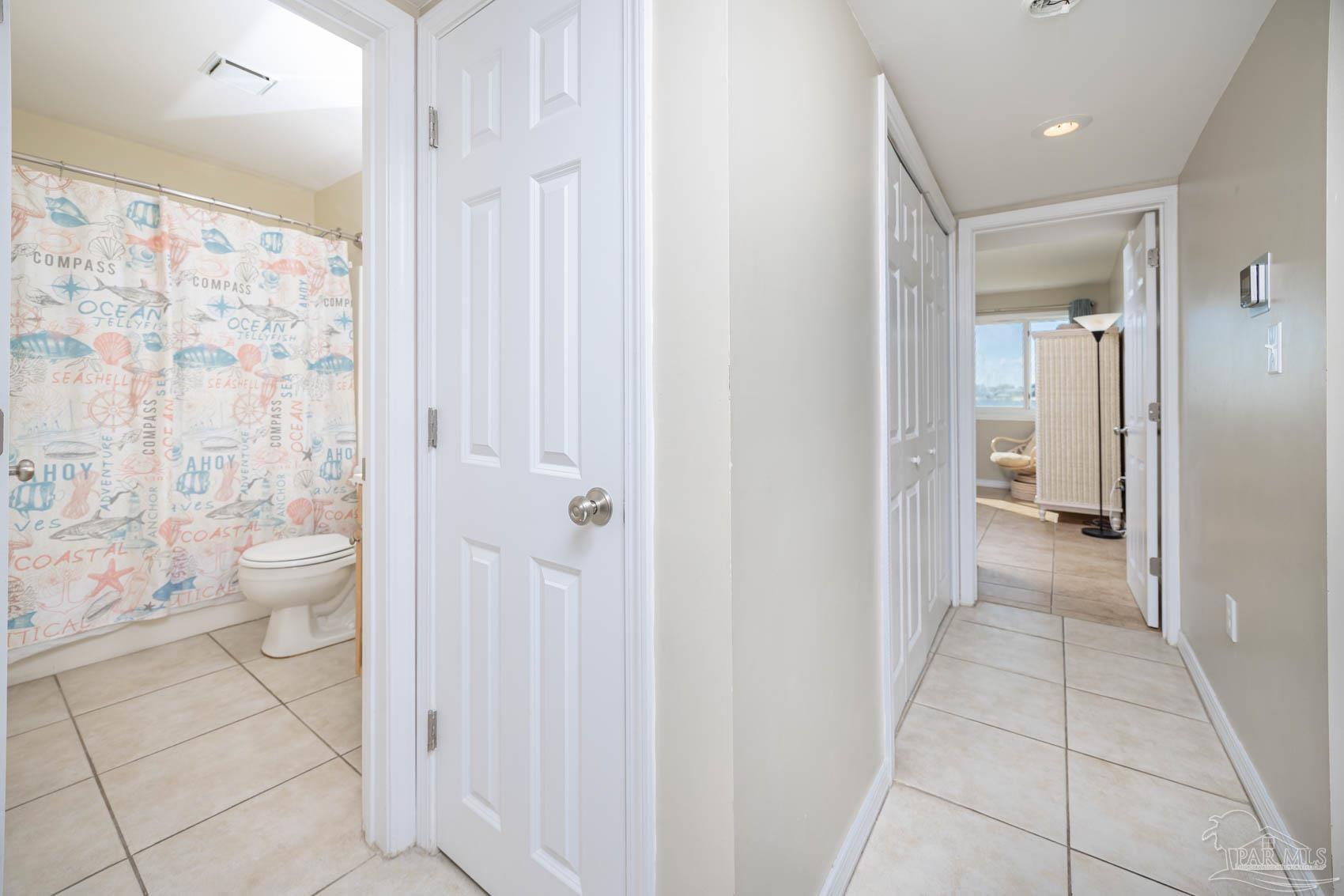 16470 Perdido Key Drive, Unit B13 Perdido Key, FL 32507 - Photo 18 of 30 a bathroom with a granite countertop sink a toilet and a shower