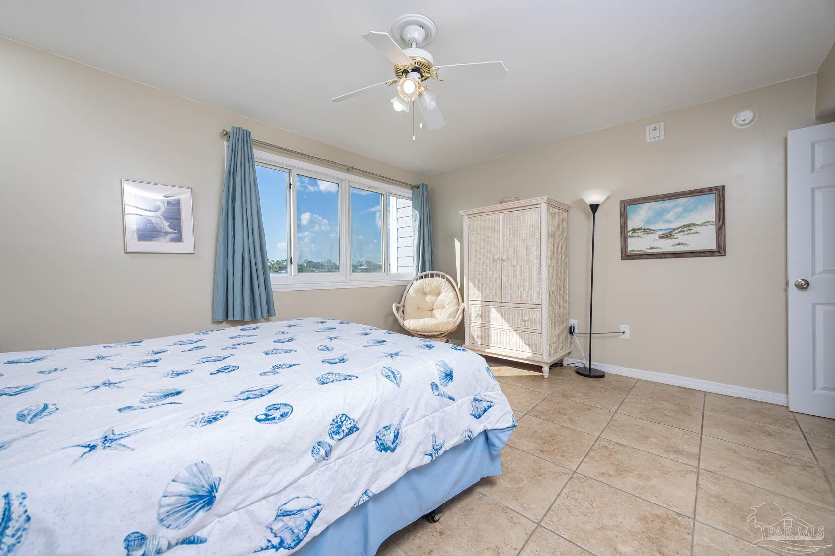16470 Perdido Key Drive, Unit B13 Perdido Key, FL 32507 - Photo 21 of 30 a bedroom with a bed and a chandelier
