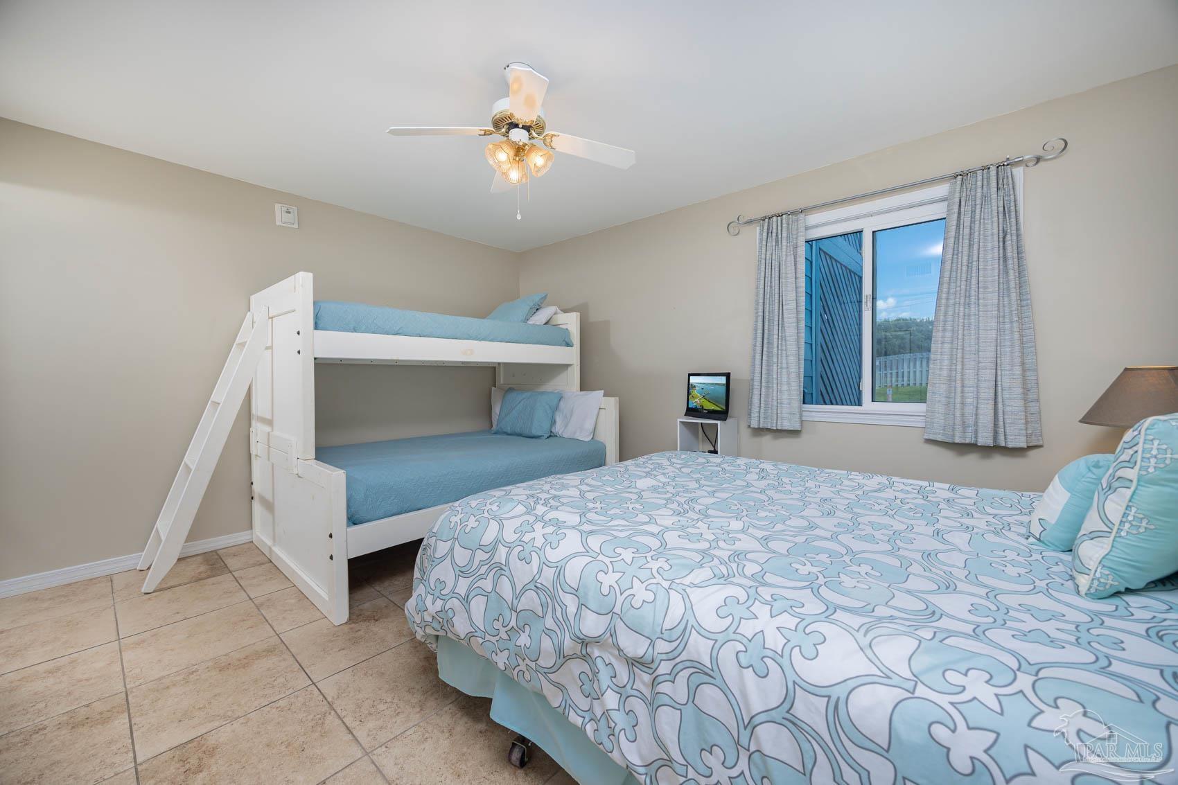16470 Perdido Key Drive, Unit B13 Perdido Key, FL 32507 - Photo 23 of 30 a bedroom with a bed and a chandelier