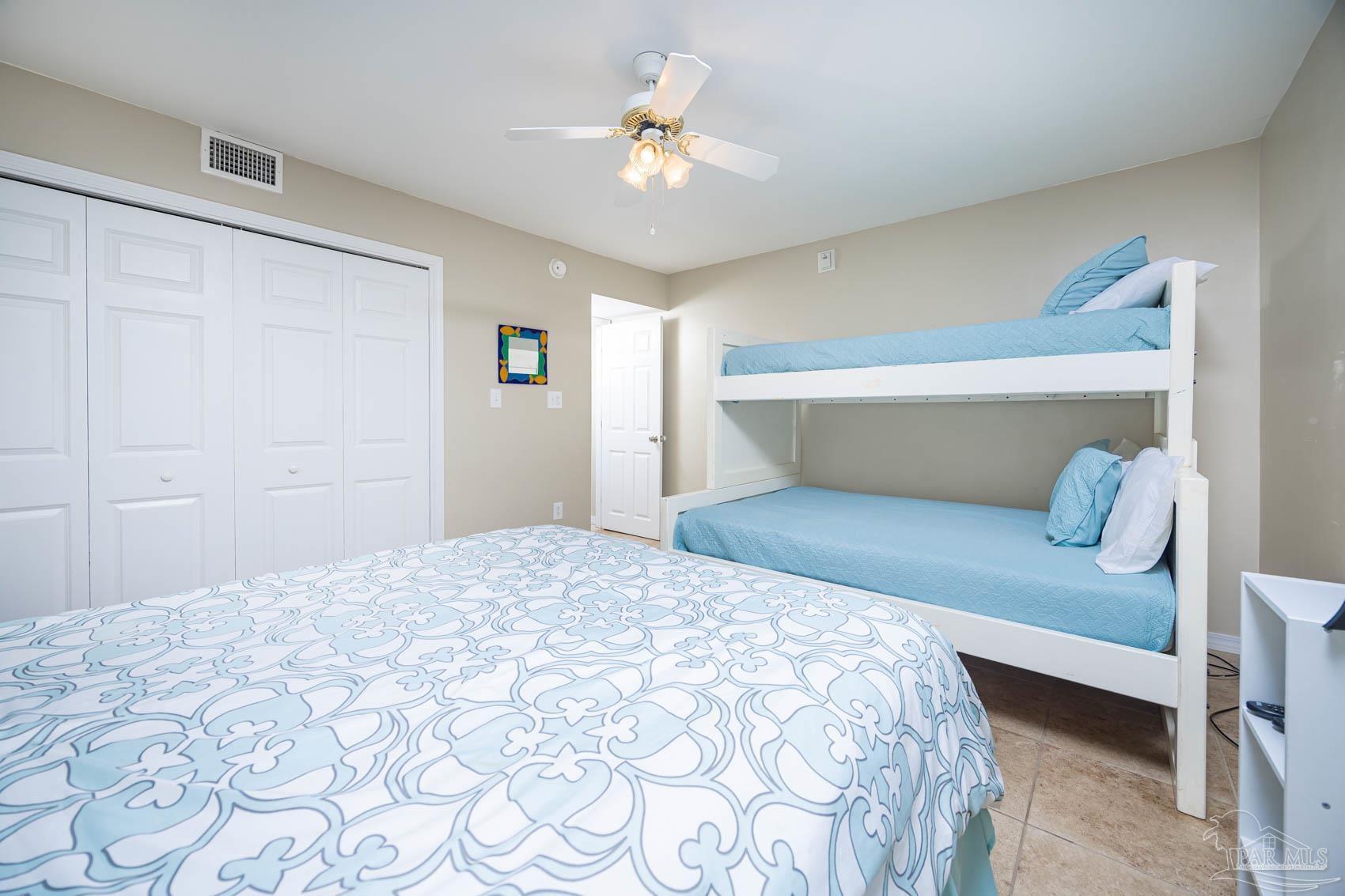 16470 Perdido Key Drive, Unit B13 Perdido Key, FL 32507 - Photo 24 of 30 a bedroom with a bed and a chandelier