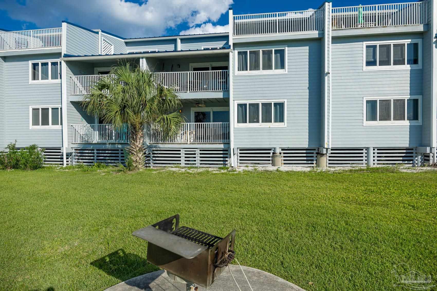 16470 Perdido Key Drive, Unit B13 Perdido Key, FL 32507 - Photo 6 of 30 a backyard of a house with lots of green space