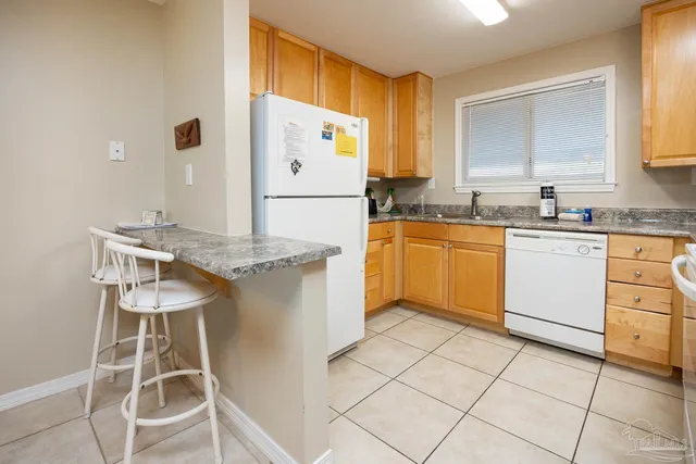 a kitchen with cabinets and chairs