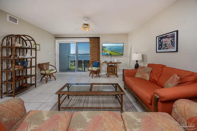 a living room with furniture fireplace and a window