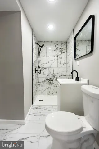 a white toilet sitting next to a bathroom sink