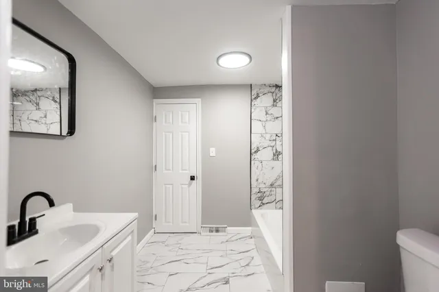 a bathroom with a bathtub and toilet