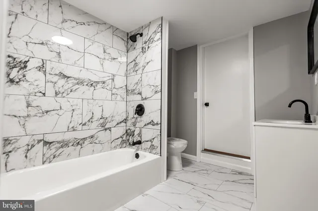 a view of a hallway with wooden floor and windows