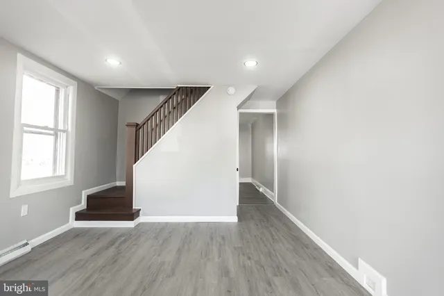 a view of entryway with wooden floor and stairs