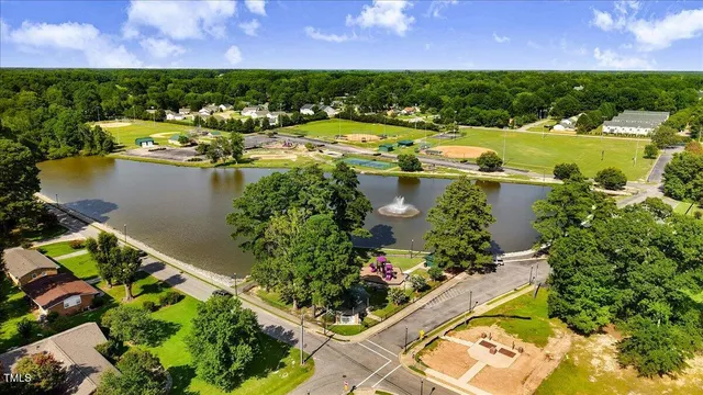 an aerial view of residential houses with outdoor space and swimming pool