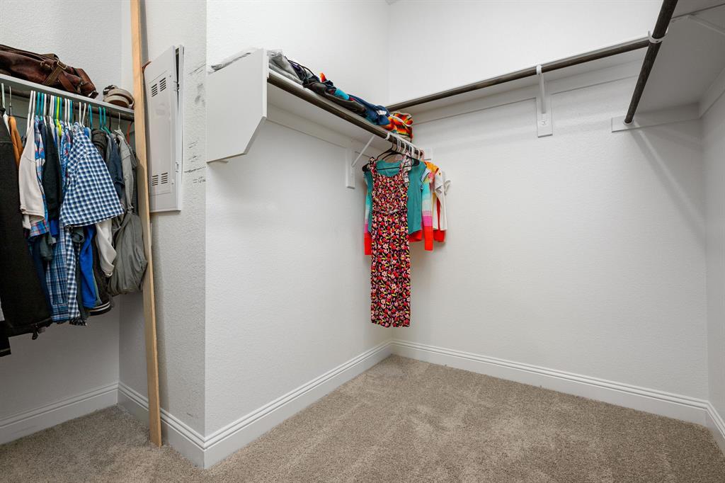 1320 Rosebush Road Aubrey, TX 76227 - Photo 21 of 33 a view of walk in closet with clothes and shoes