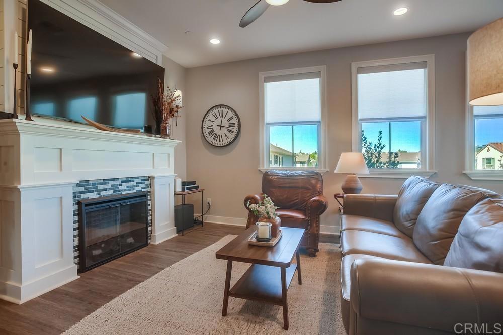 4326 Star Path Way, Unit 1 Oceanside, CA 92056 - Photo 14 of 72 a living room with furniture a large window and a fireplace