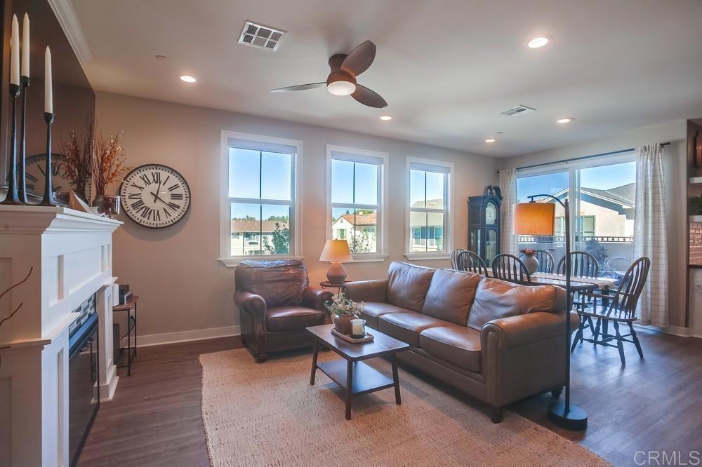 4326 Star Path Way, Unit 1 Oceanside, CA 92056 - Photo 15 of 72 a living room with furniture a fireplace and a large window