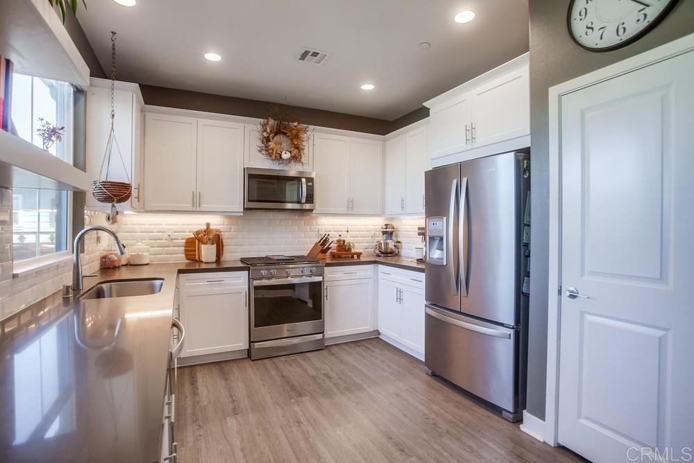 4326 Star Path Way, Unit 1 Oceanside, CA 92056 - Photo 26 of 72 a kitchen with a refrigerator stove and sink