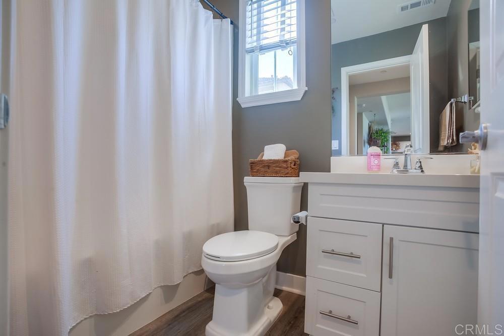 4326 Star Path Way, Unit 1 Oceanside, CA 92056 - Photo 31 of 72 a bathroom with a toilet sink and mirror