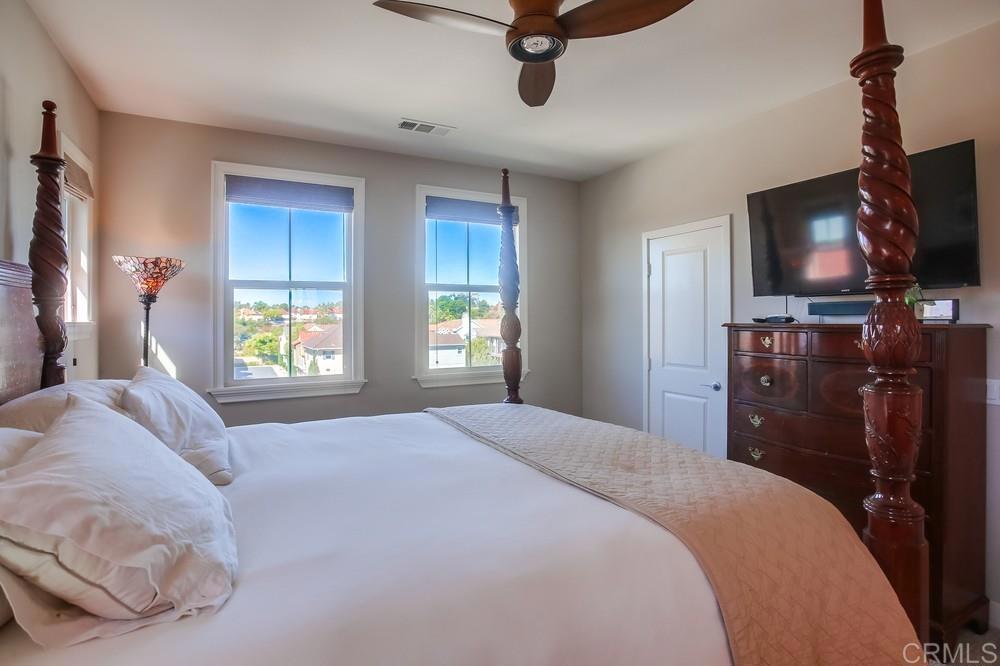 4326 Star Path Way, Unit 1 Oceanside, CA 92056 - Photo 40 of 72 a bedroom with a bed and a flat tv screen on the dresser