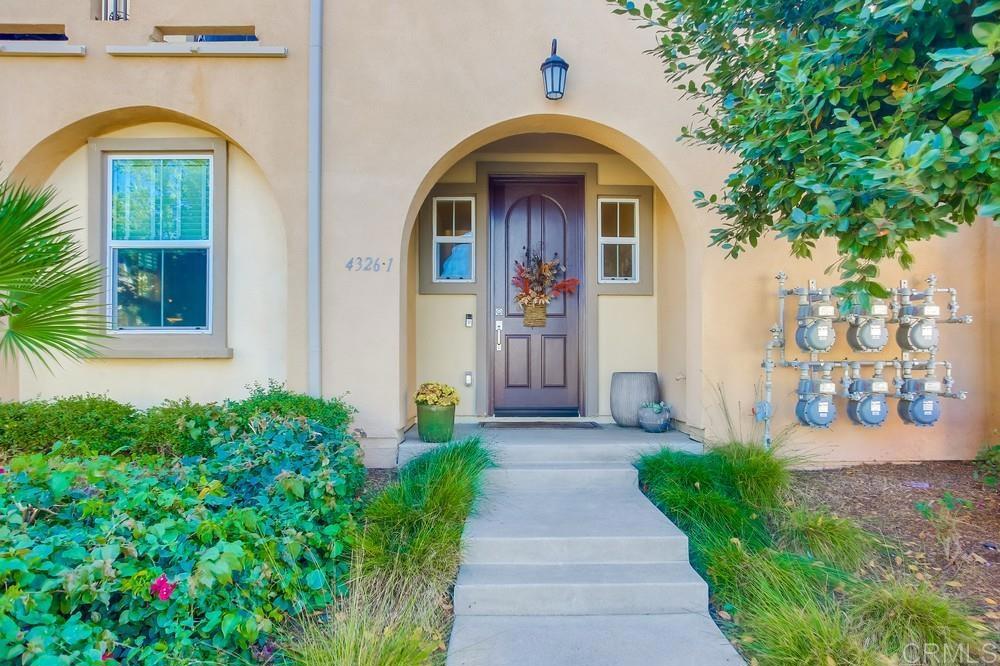 4326 Star Path Way, Unit 1 Oceanside, CA 92056 - Photo 4 of 72 a front view of a house with a porch