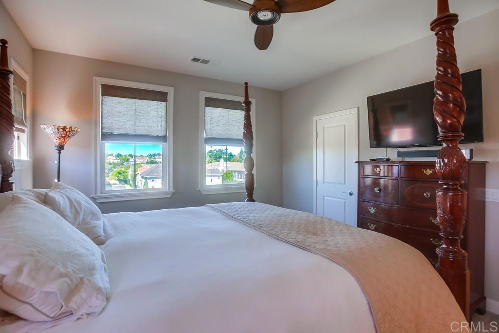 4326 Star Path Way, Unit 1 Oceanside, CA 92056 - Photo 41 of 72 a bedroom with a bed and a flat tv screen on the dresser