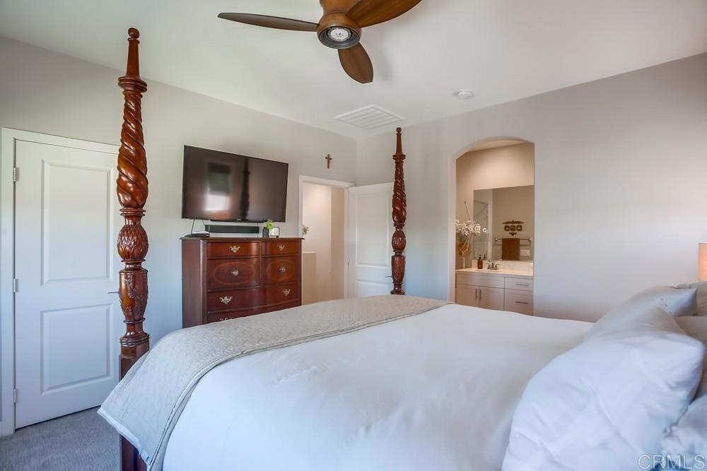 4326 Star Path Way, Unit 1 Oceanside, CA 92056 - Photo 44 of 72 a bedroom with a bed and a flat tv screen on dresser