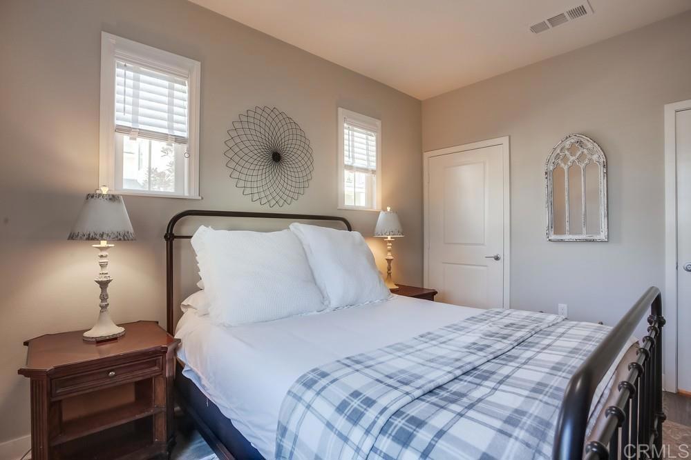 4326 Star Path Way, Unit 1 Oceanside, CA 92056 - Photo 8 of 72 a bedroom with a bed and a night stand