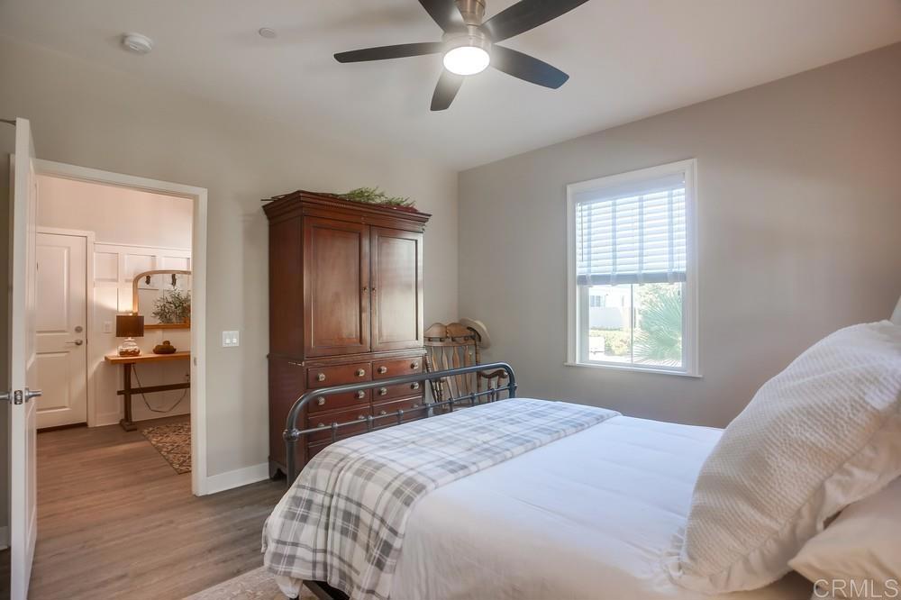 4326 Star Path Way, Unit 1 Oceanside, CA 92056 - Photo 9 of 72 a bedroom with a bed and wooden floor