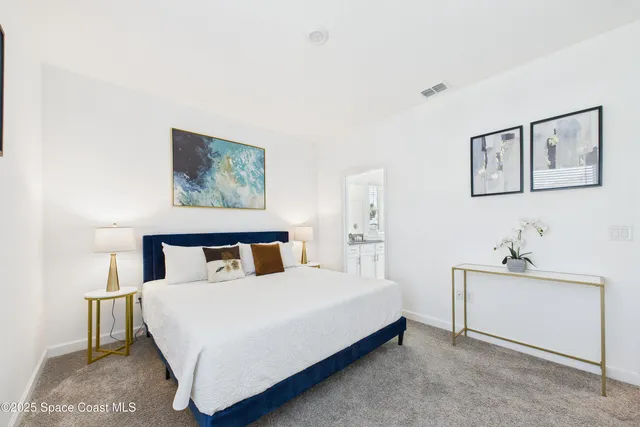 a bedroom with a bed and wall painting