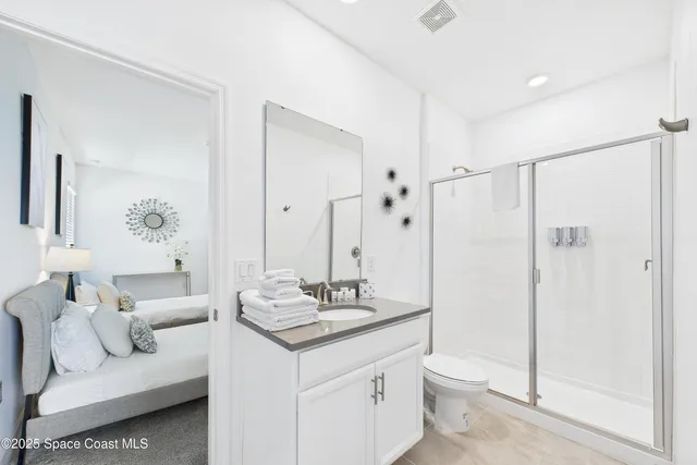 a bathroom with a double vanity sink toilet and shower