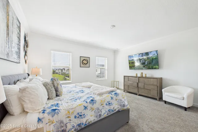 a bedroom with a bed and a couch