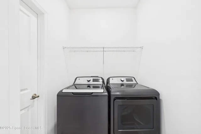 a view of a brick house with a flower garden