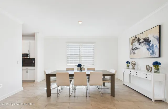 a view of a dining room with furniture and window