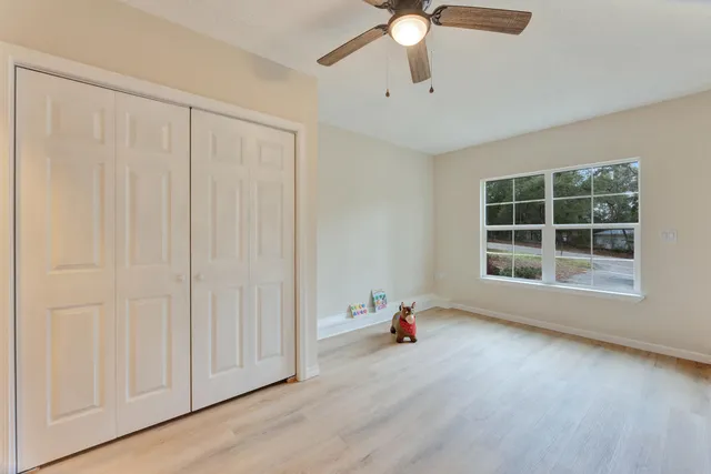 an empty room with windows and closet