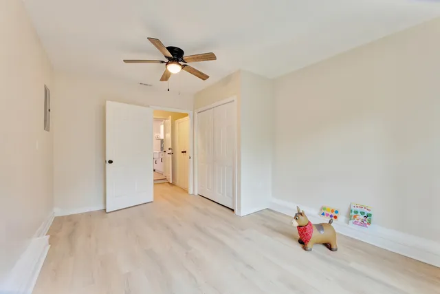 a view of empty room with closet and fan