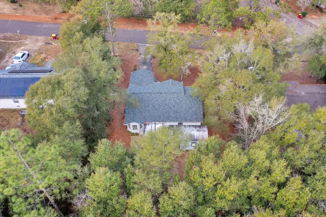 an aerial view of a house with a yard