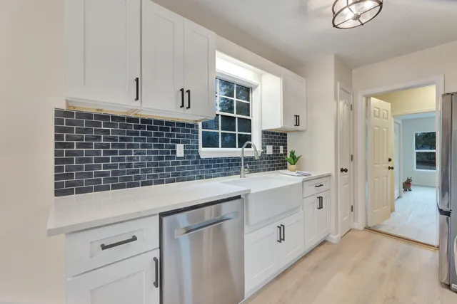 a kitchen with a sink and cabinets