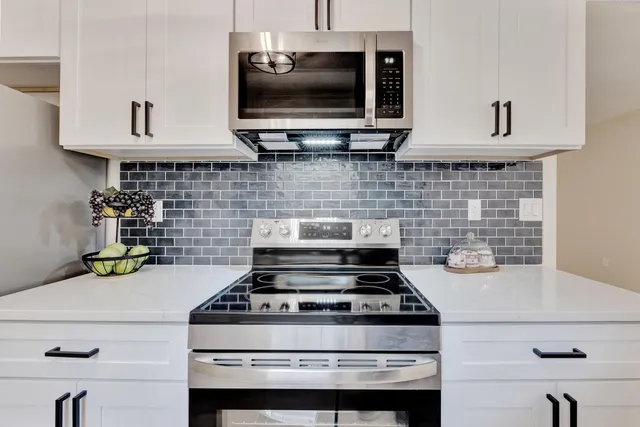 a stove top oven sitting inside of a kitchen