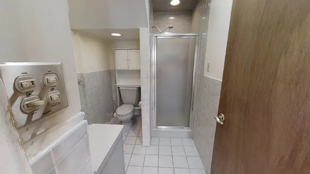 a bathroom with a toilet sink and shower