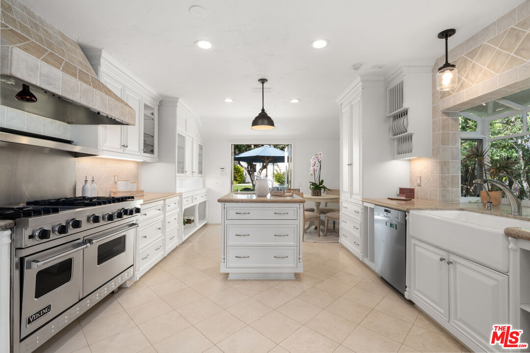 31202 Broad Beach Road Malibu, CA 90265 - Photo 11 of 38 a kitchen with stainless steel appliances a stove sink and cabinets
