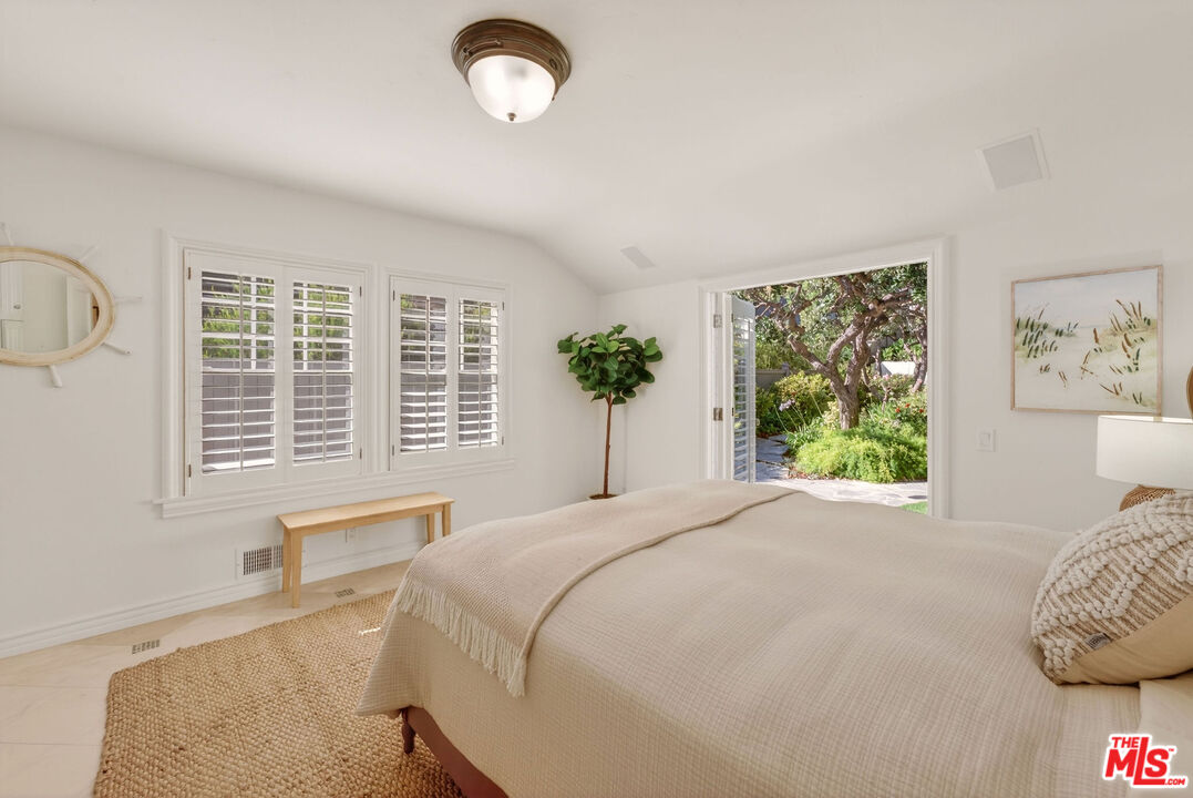 31202 Broad Beach Road Malibu, CA 90265 - Photo 14 of 38 a bedroom with a large bed and a large window