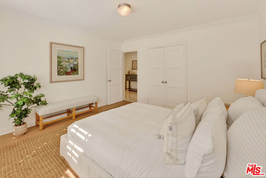 31202 Broad Beach Road Malibu, CA 90265 - Photo 17 of 38 a bedroom with a bed and a potted plant