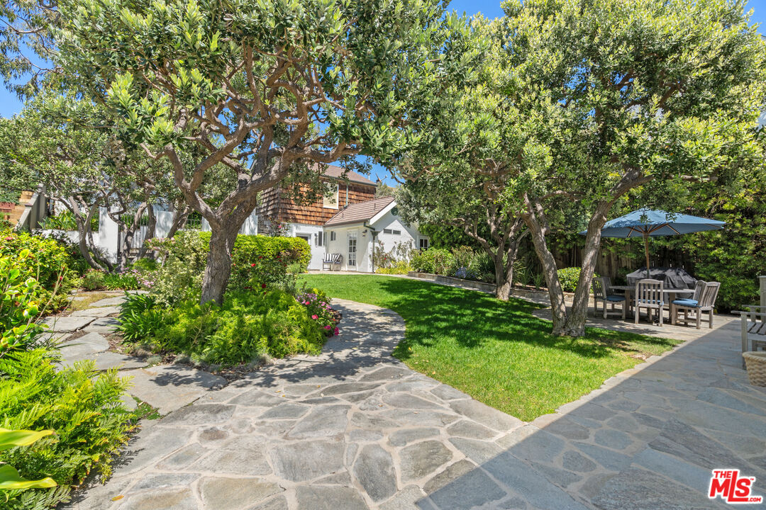 31202 Broad Beach Road Malibu, CA 90265 - Photo 29 of 38 a view of a patio with table and chairs under an umbrella