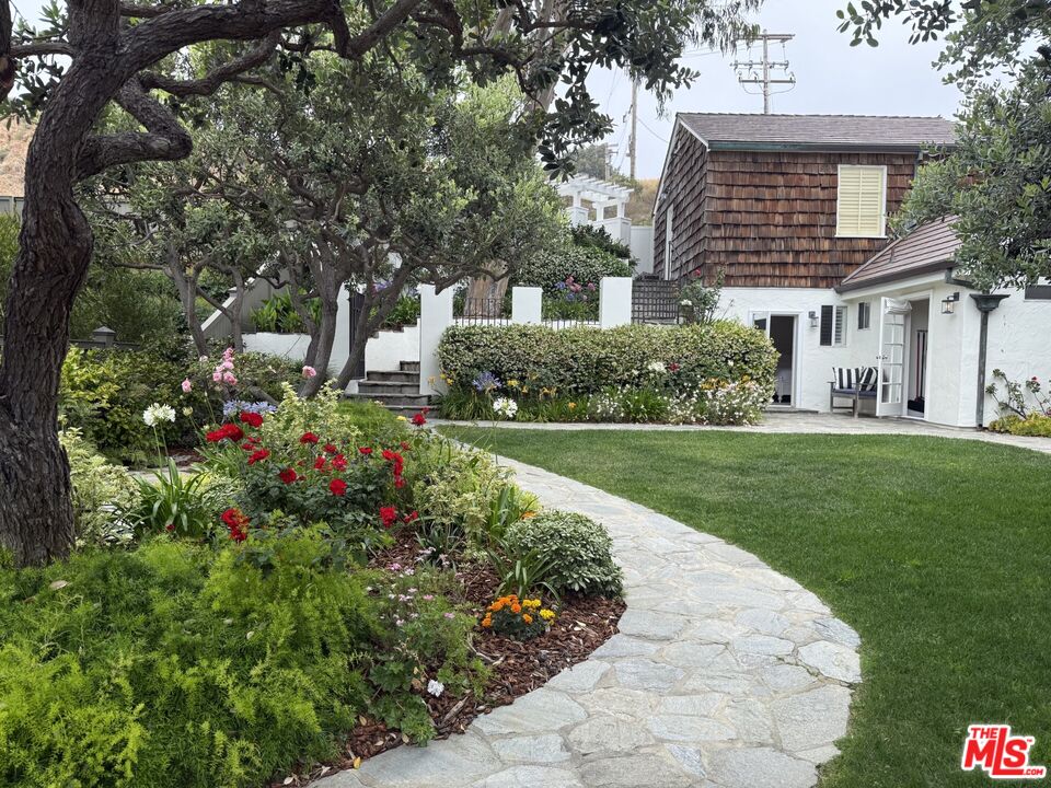 31202 Broad Beach Road Malibu, CA 90265 - Photo 30 of 38 a front view of a house with a yard