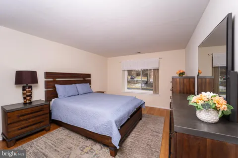 a bedroom with a bed and a potted plant