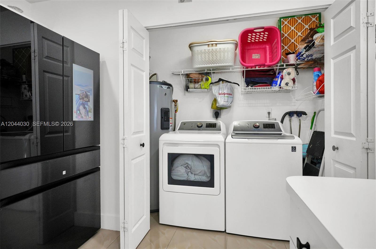 12551 Southwest 223rd Street Miami, FL 33170 - Photo 10 of 35 a kitchen with stainless steel appliances a refrigerator and a stove