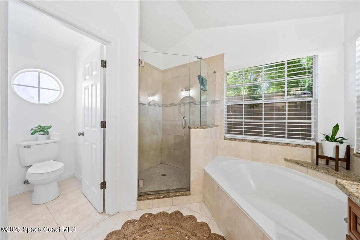 3510 Holly Springs Road Melbourne, FL 32934 - Photo 15 of 25 a bathroom with a tub a toilet and a shower