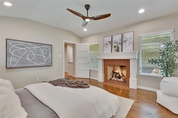 a bedroom with a bed and a fireplace
