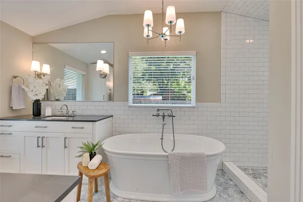 a bath room with a sink and a mirror