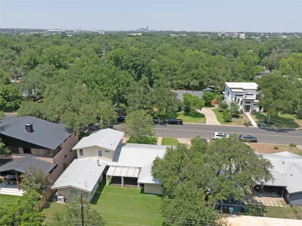 an aerial view of a house with garden space and street view