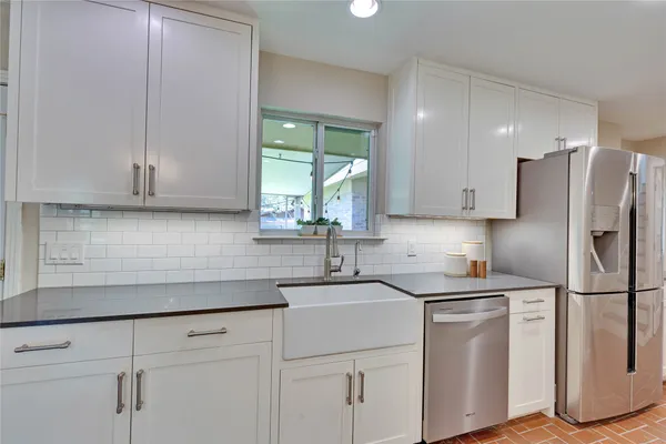 a kitchen with a sink cabinets and stainless steel appliances