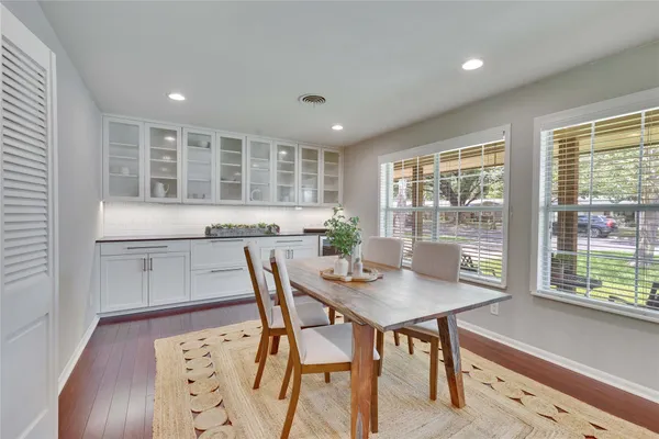 a view of a dining room with furniture and wooden floor