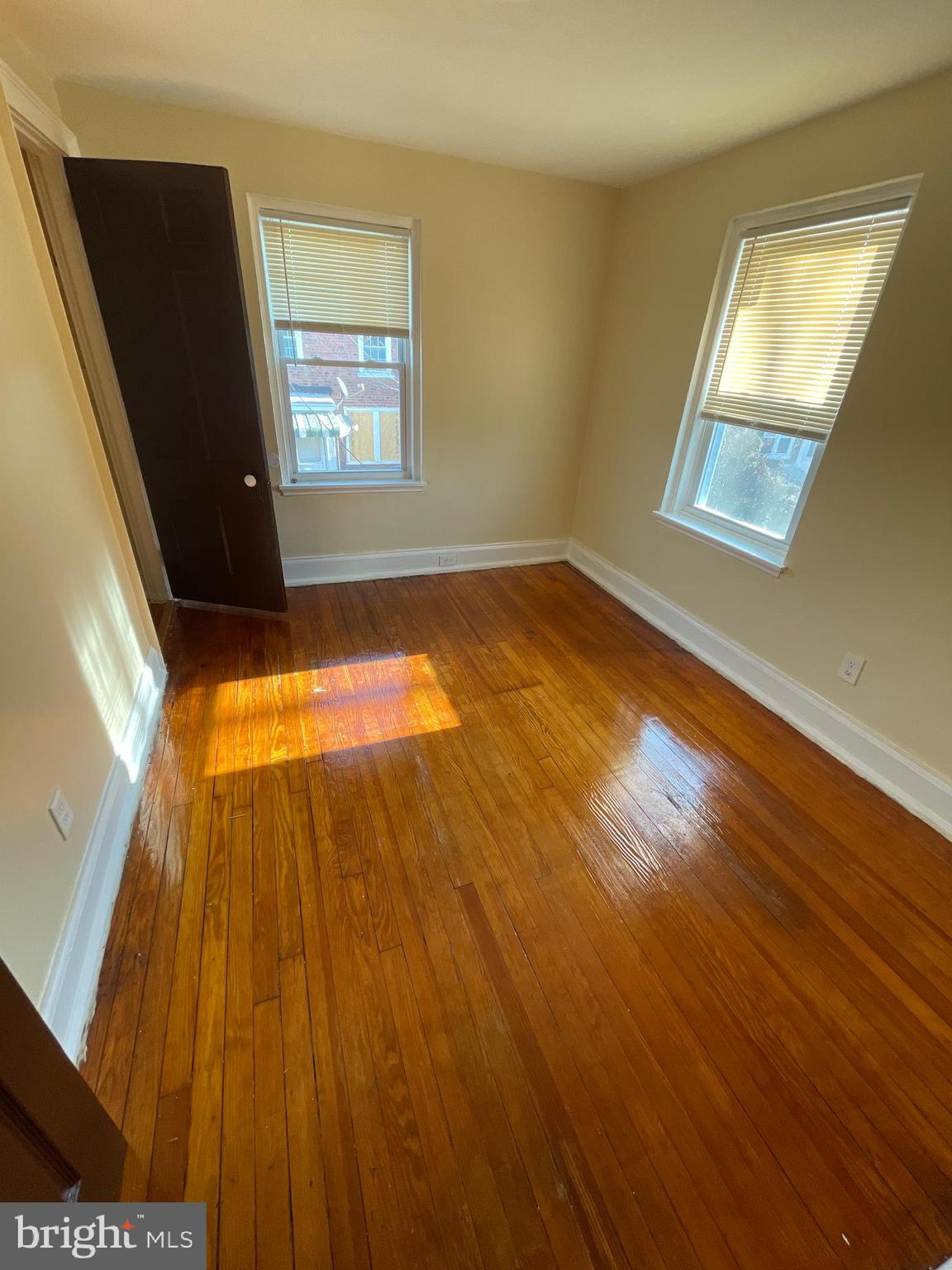 1344 Argus Road Camden, NJ 08104 - Photo 5 of 10 a view of an empty room with wooden floor and a window